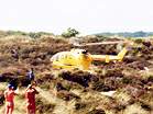 Emergency helicopter lands in dunes  Studland United Nudists